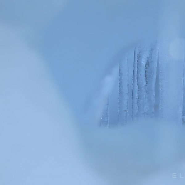 Blue icecycles seen through a hole in a alrger piece of ice in the Khumbu Icefall