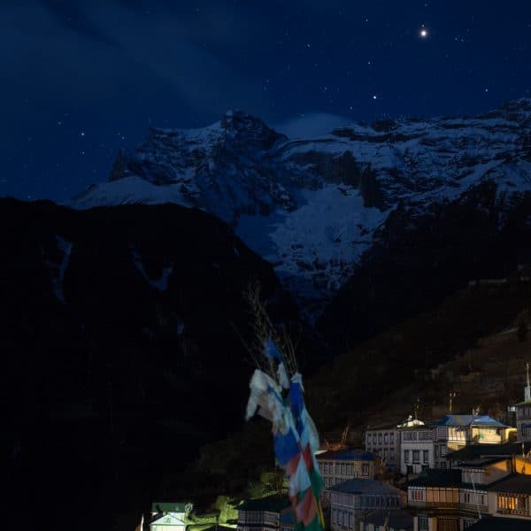 A village in the mountains at night with stone hotels