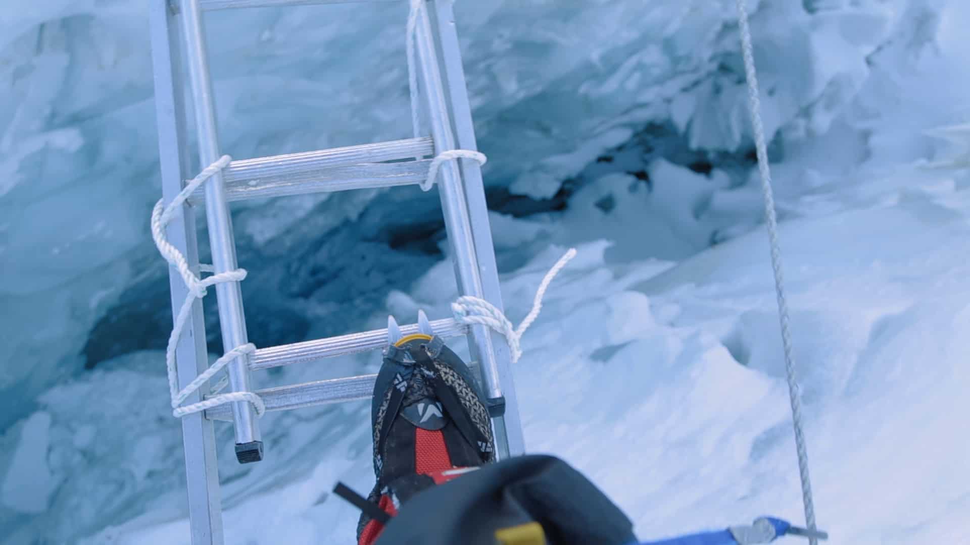 POV crossing a ladder on Mt Everest in the Khumbu Icefall Elia Saikaly Licensing