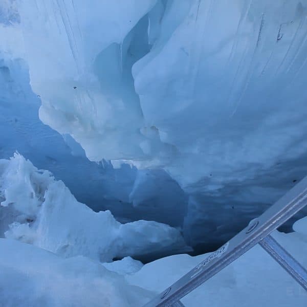 view of a crevasse from next to an aluminum ladder