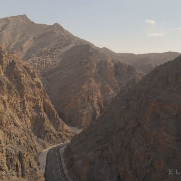 A road in the rocky tall mountains in the UAE at sunset